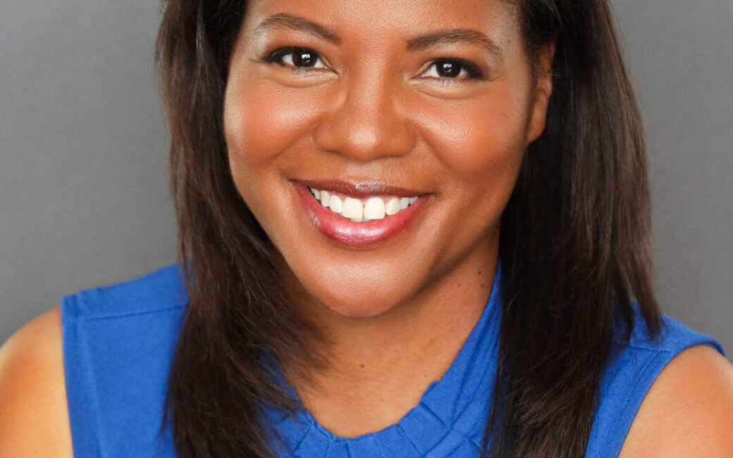 erika is a young black model smiling in a blue top