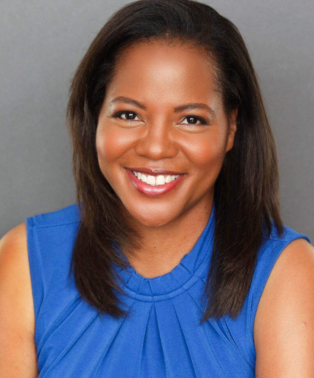 erika is a young black model smiling in a blue top